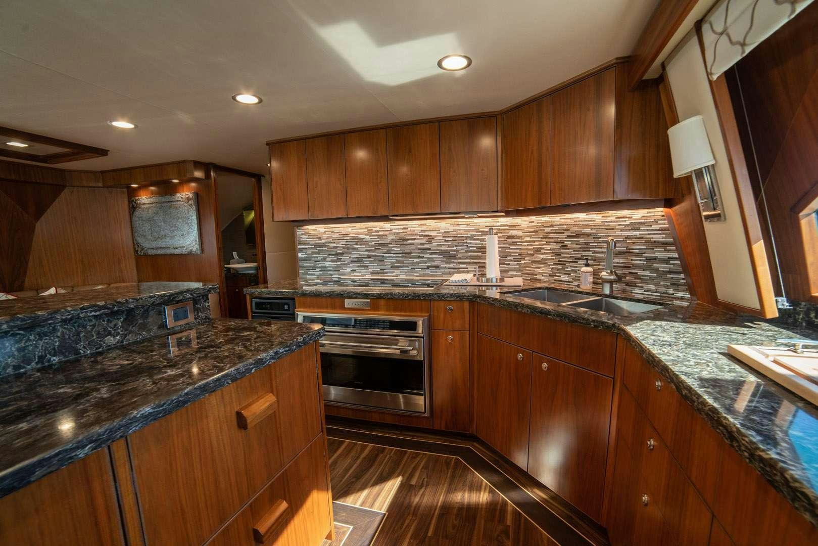 a kitchen with wooden cabinets aboard FA-LA-ME Yacht for Charter