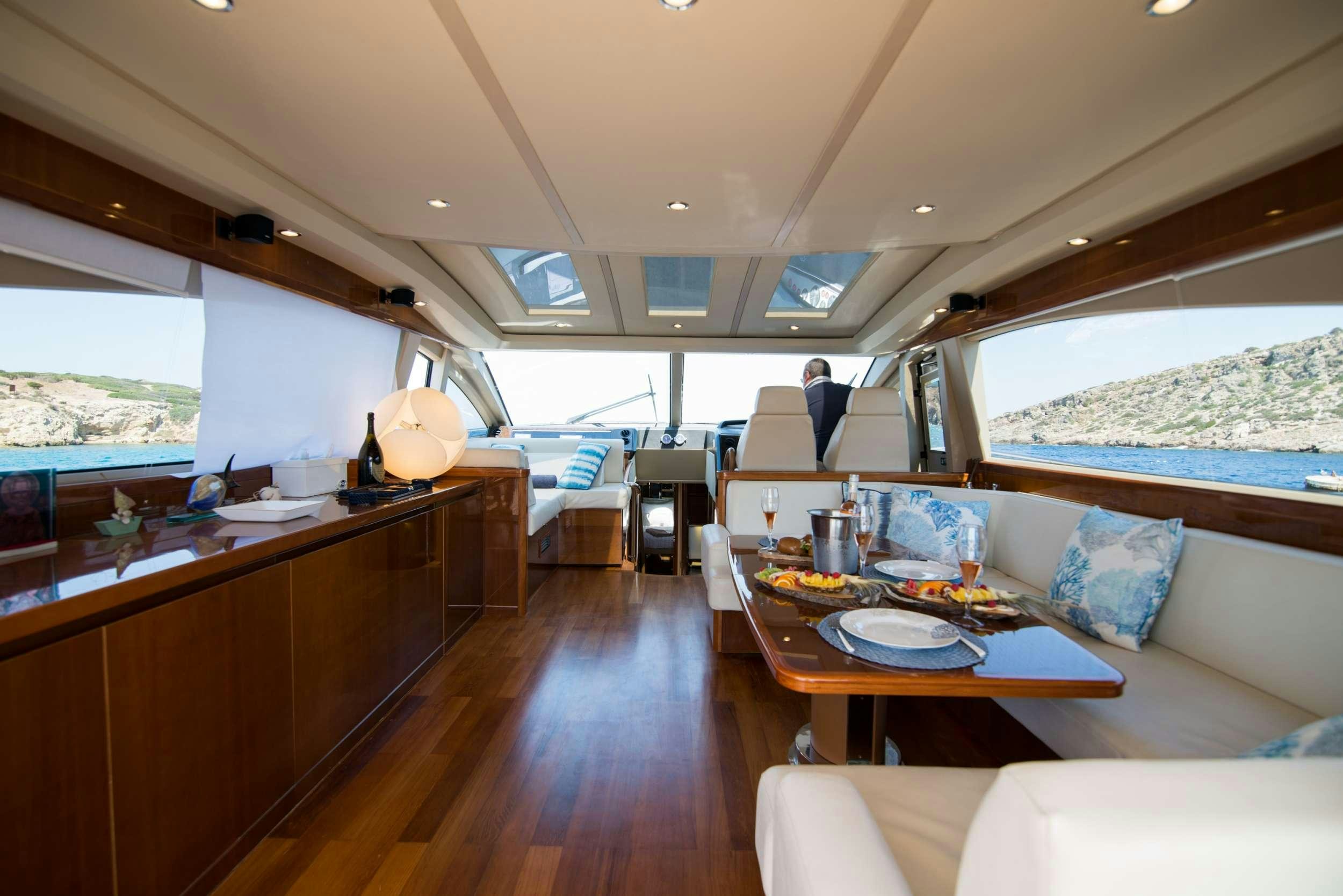 a room with a bed and a table aboard MOJO Yacht for Charter