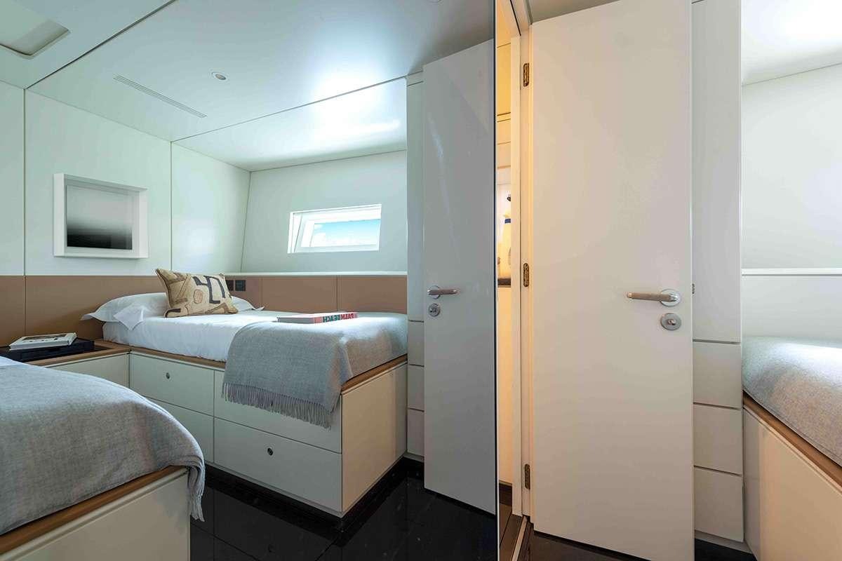 a room with a bed and a door aboard RUNNING ON FAITH Yacht for Charter