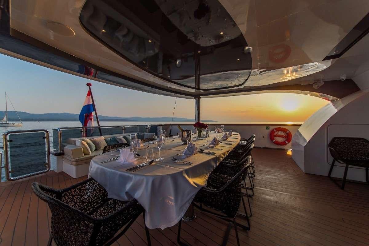 a dining table on a boat aboard OMNIA Yacht for Charter