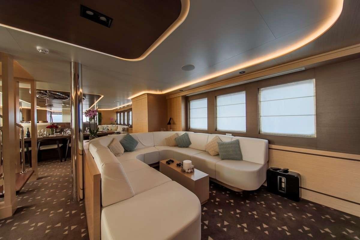 a living room with a couch and a table aboard OMNIA Yacht for Charter