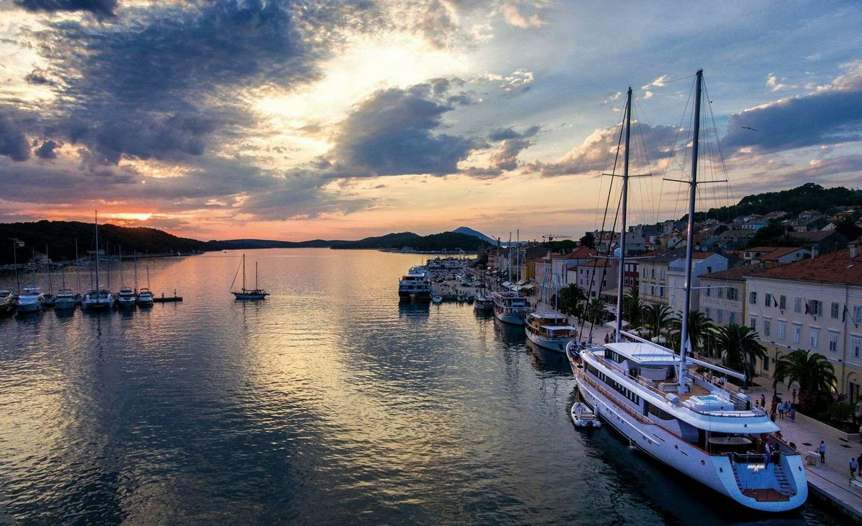 boats in a harbor aboard OMNIA Yacht for Charter