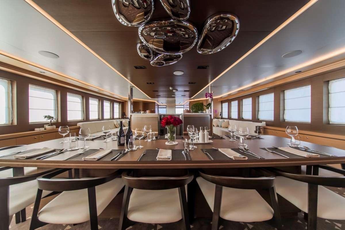 a large dining room table aboard OMNIA Yacht for Charter