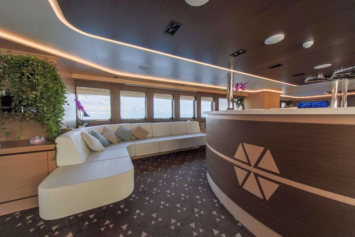 a room with a couch and a table aboard OMNIA Yacht for Charter