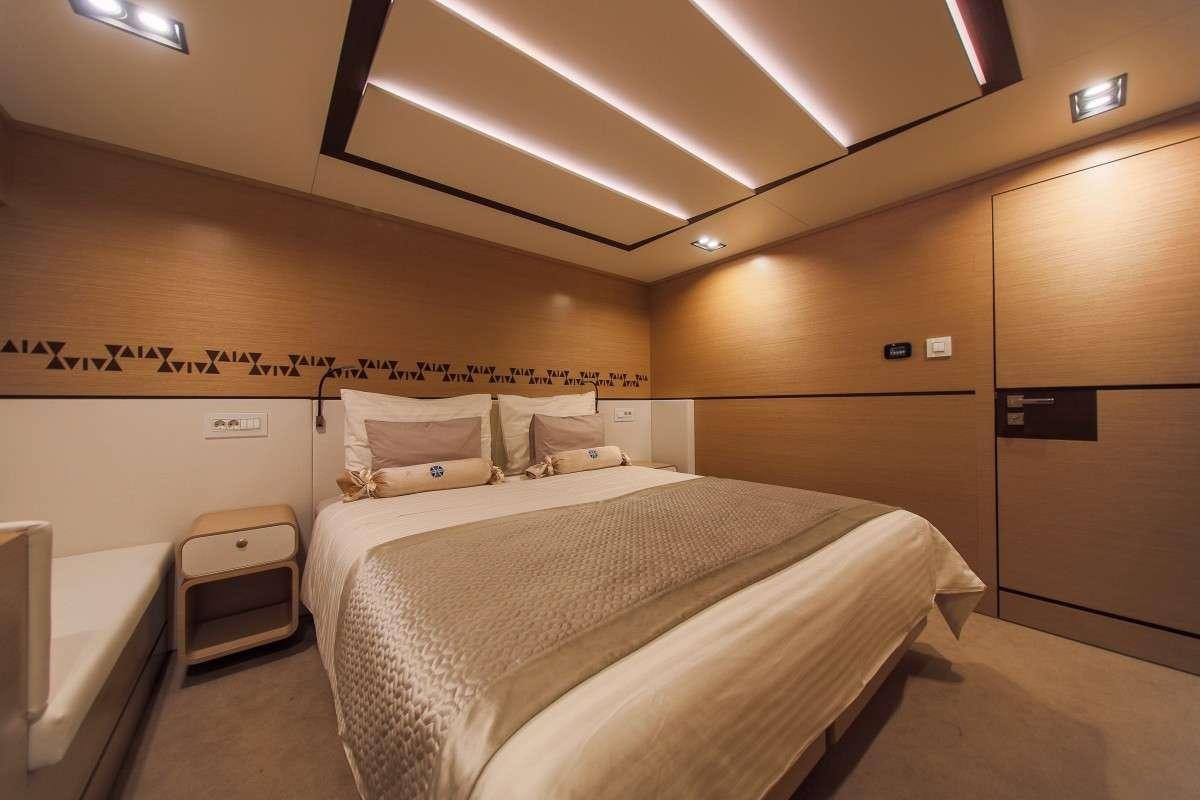 a room with two beds aboard OMNIA Yacht for Charter