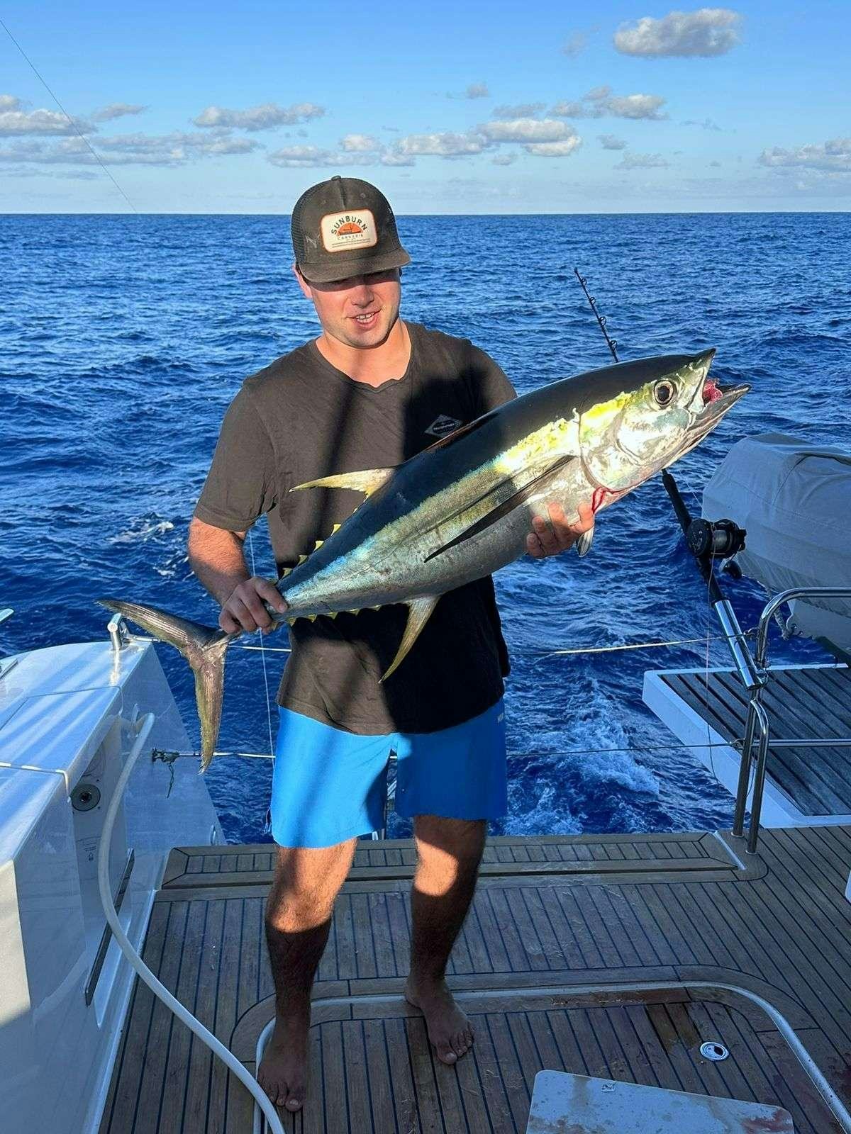 a person holding a fish aboard TRU NORTH Yacht for Charter