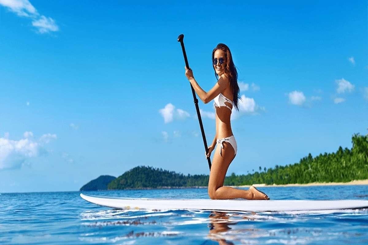 a person sitting on a beach holding a sword aboard TRU NORTH Yacht for Charter