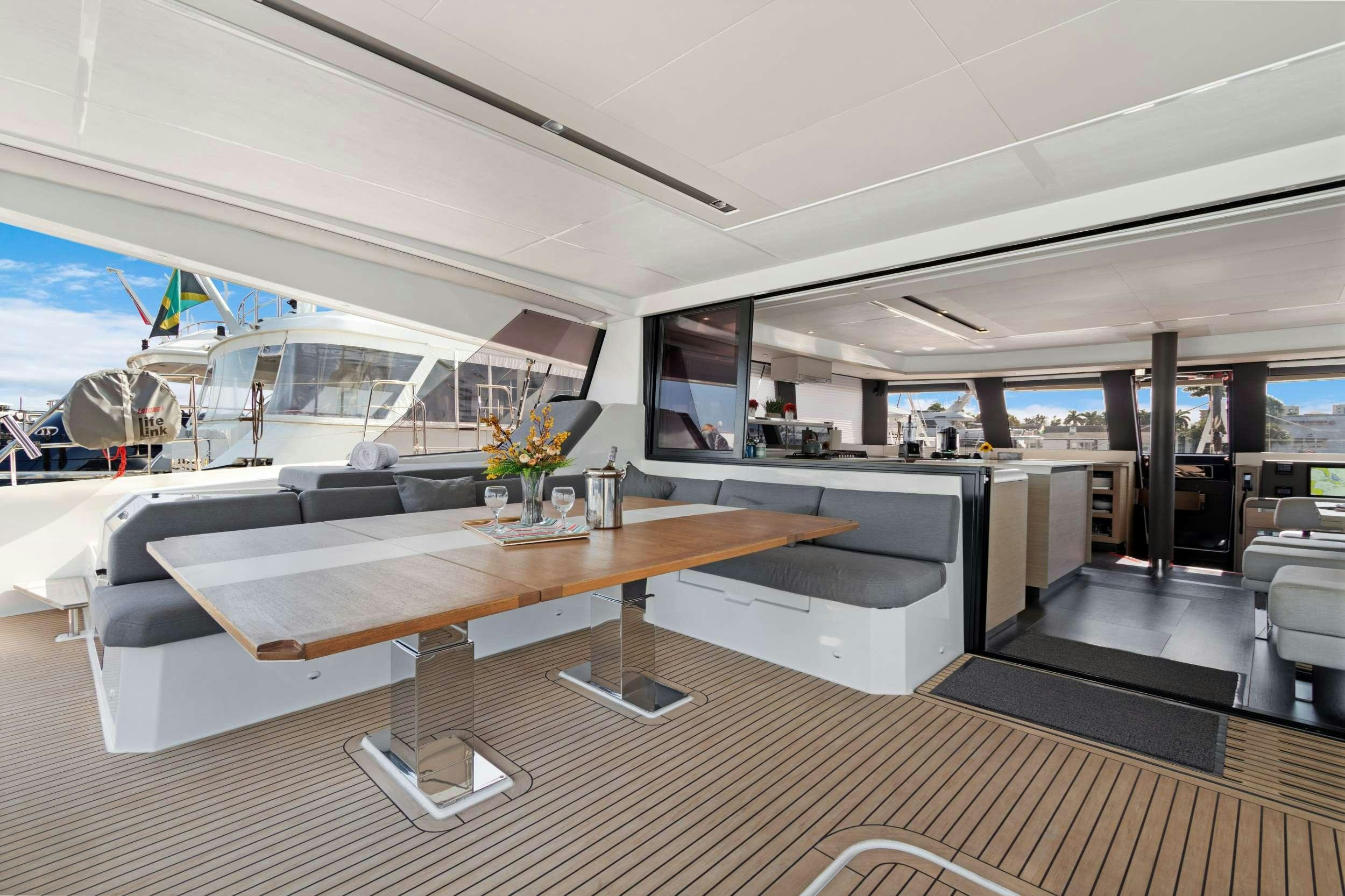 a room with a table and chairs aboard TRU NORTH Yacht for Charter