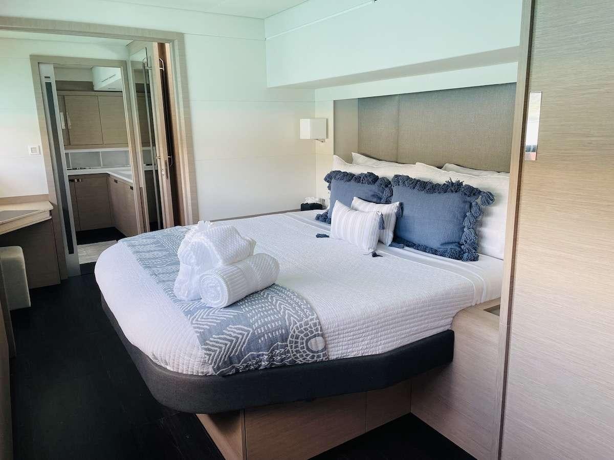 a bed with a white sheet aboard TRU NORTH Yacht for Charter