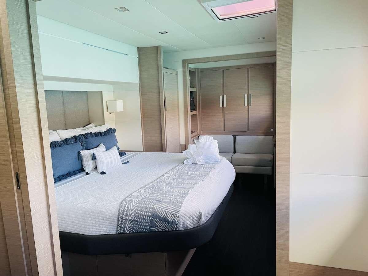 a room with a bed and a couch aboard TRU NORTH Yacht for Charter