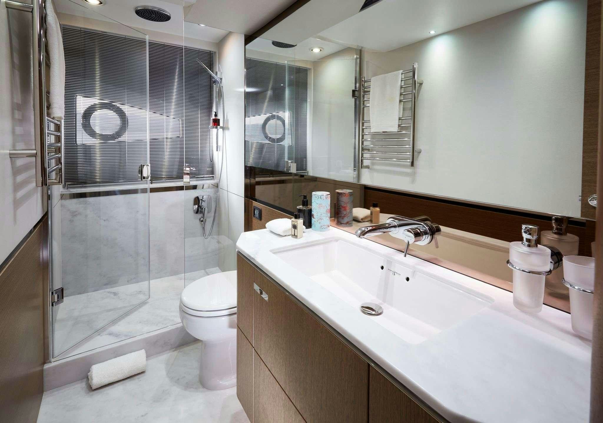 a bathroom with a glass shower aboard MESOFA Yacht for Charter