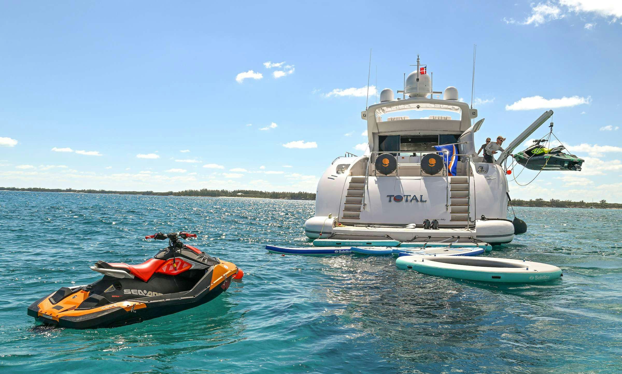 a boat and a motorbike on the water aboard TOTAL Yacht for Charter