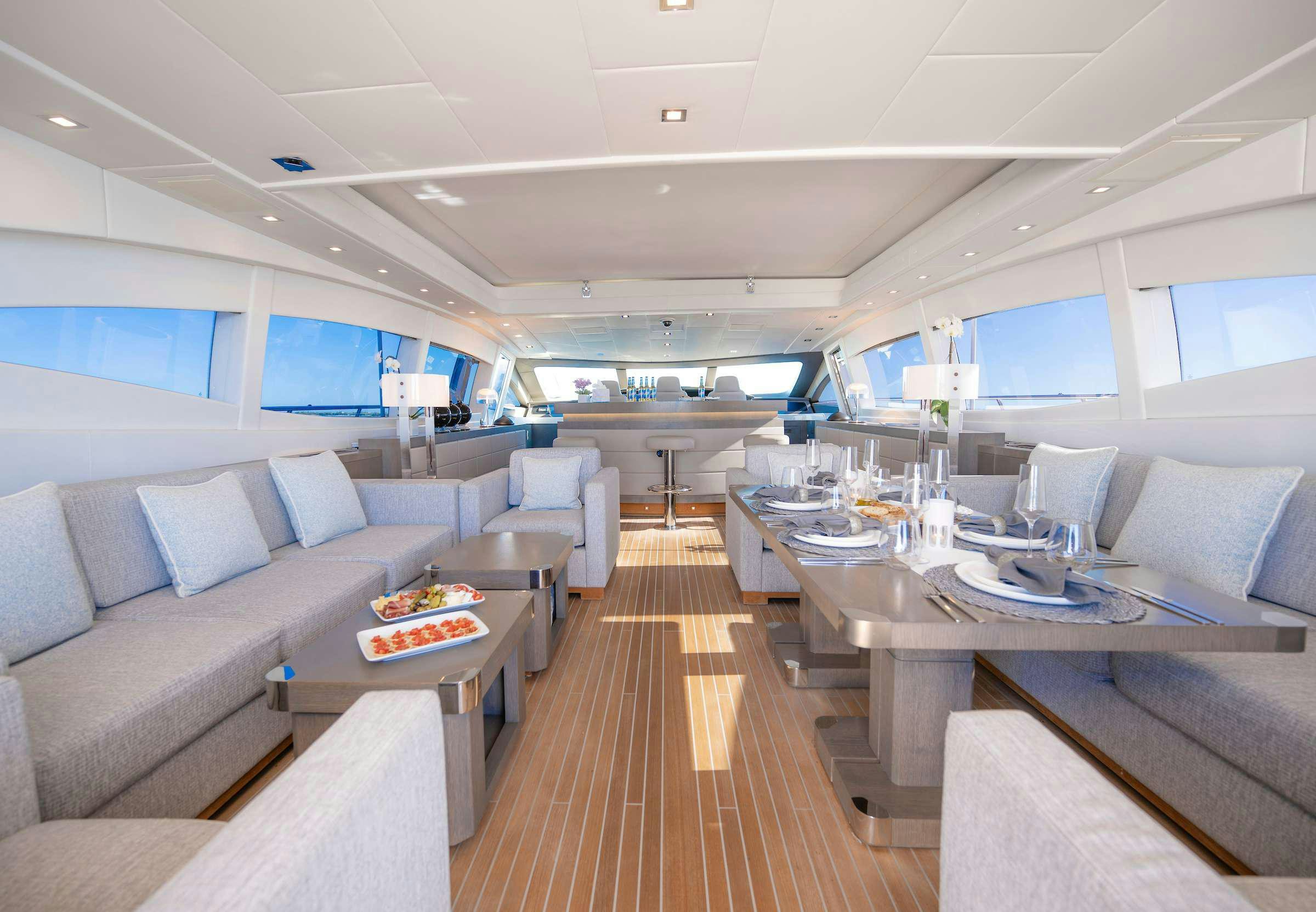 a room with a couch and a table aboard TOTAL Yacht for Charter