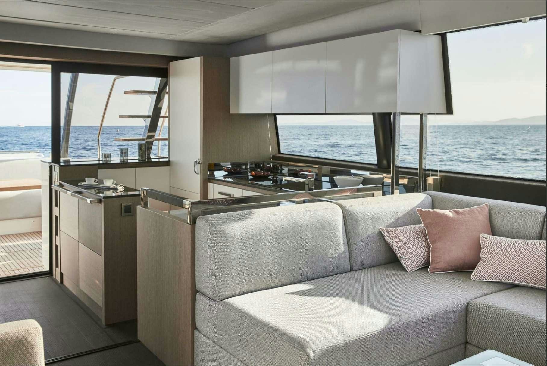 a living room with a large window aboard BAZINGA Yacht for Charter