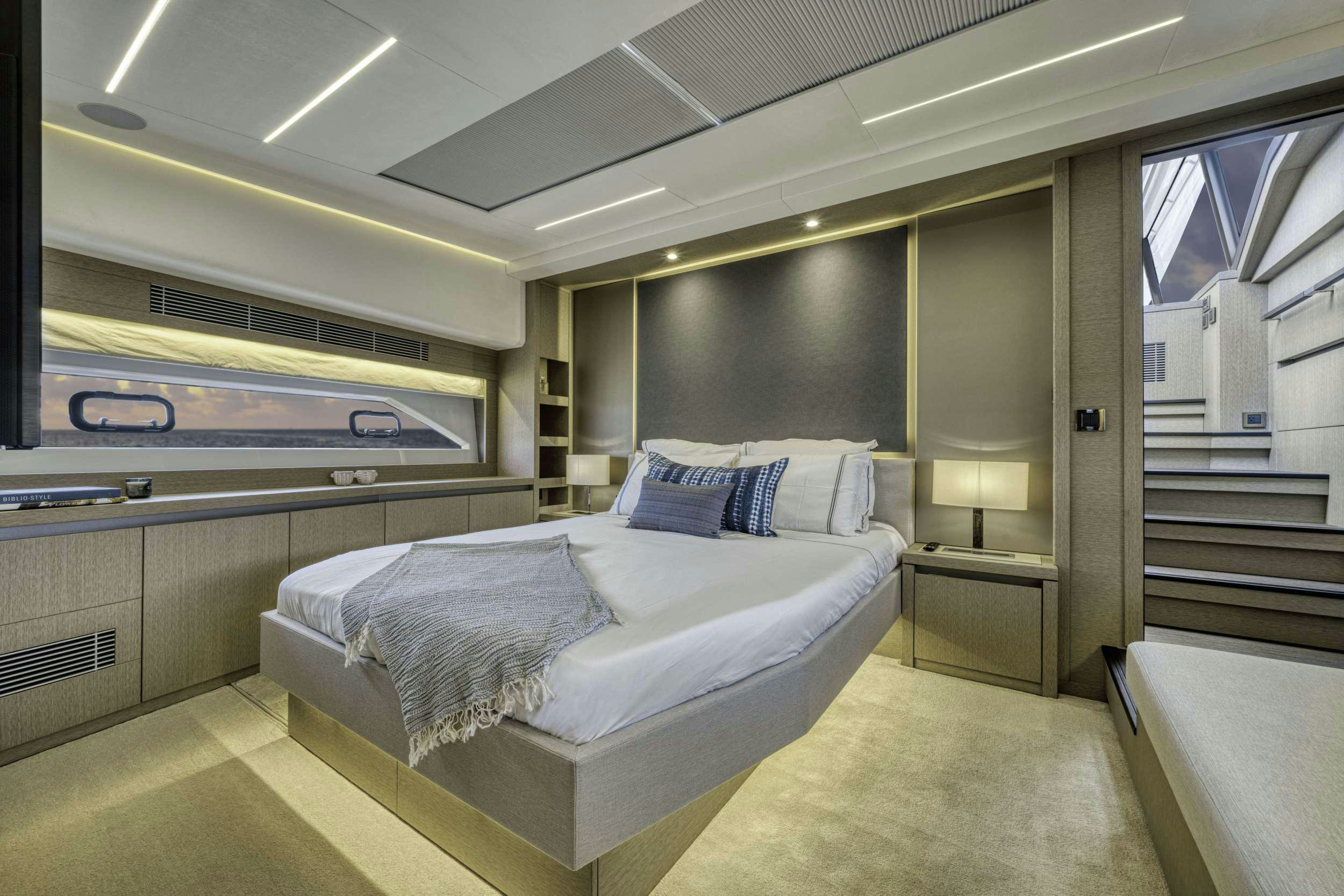 a room with a bed and a window aboard BAZINGA Yacht for Charter