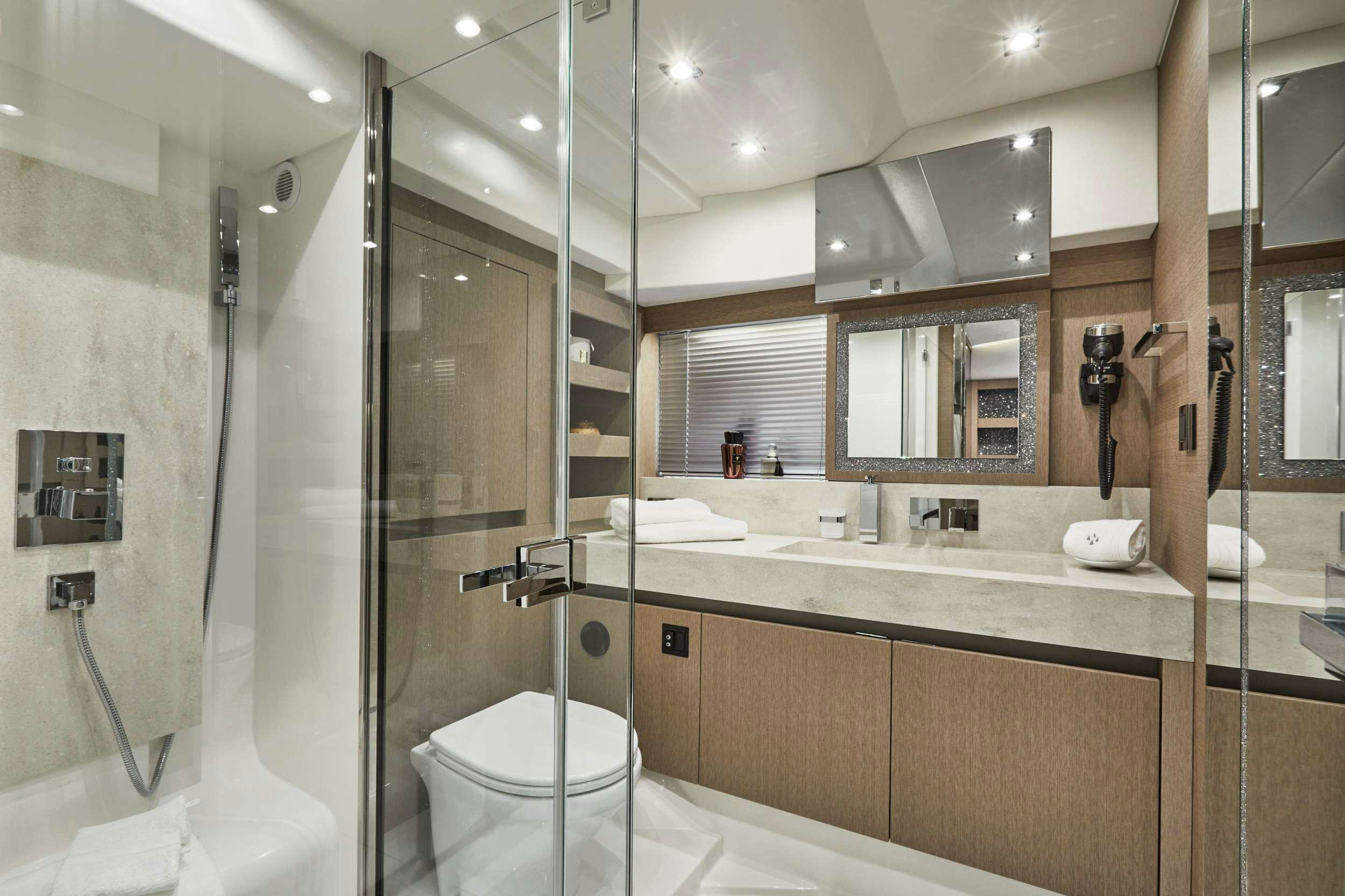 a bathroom with a glass shower aboard BAZINGA Yacht for Charter