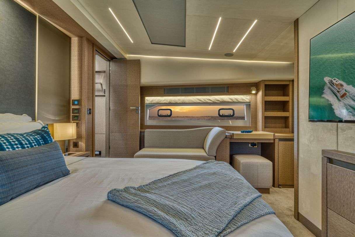 a bedroom with a bed and a desk aboard BAZINGA Yacht for Charter
