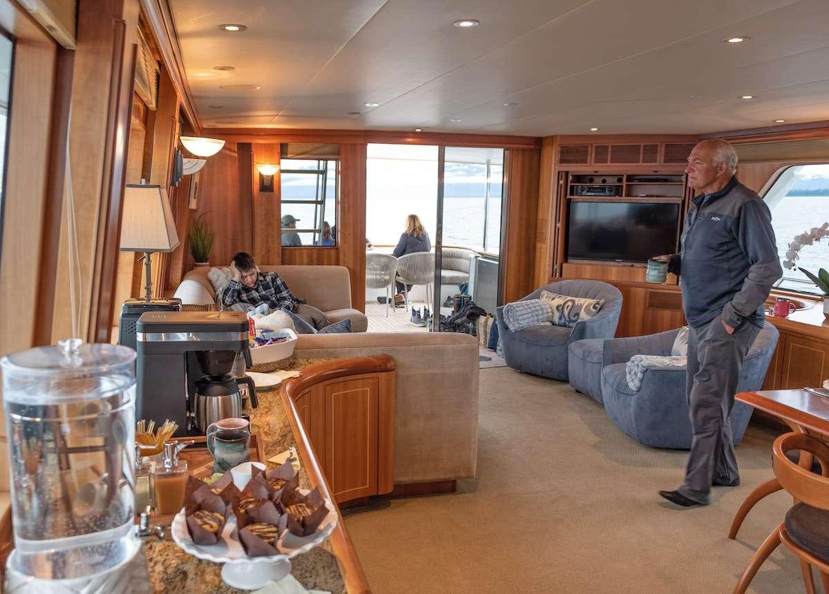 a person standing in a living room aboard DAUNTLESS Yacht for Charter