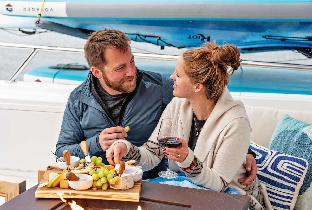 a man and a woman eating at a table aboard DAUNTLESS Yacht for Charter
