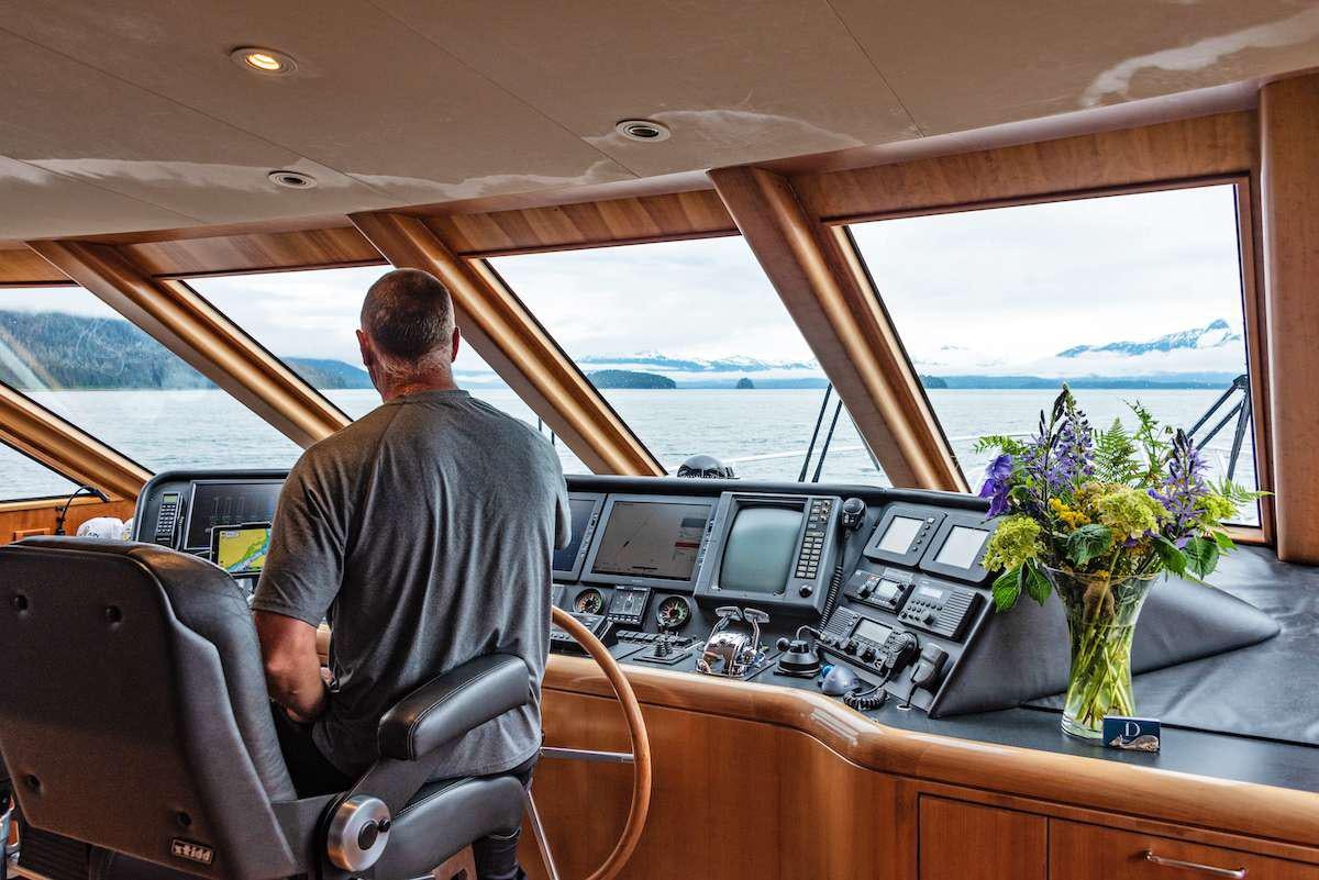 a man driving a car aboard DAUNTLESS Yacht for Charter