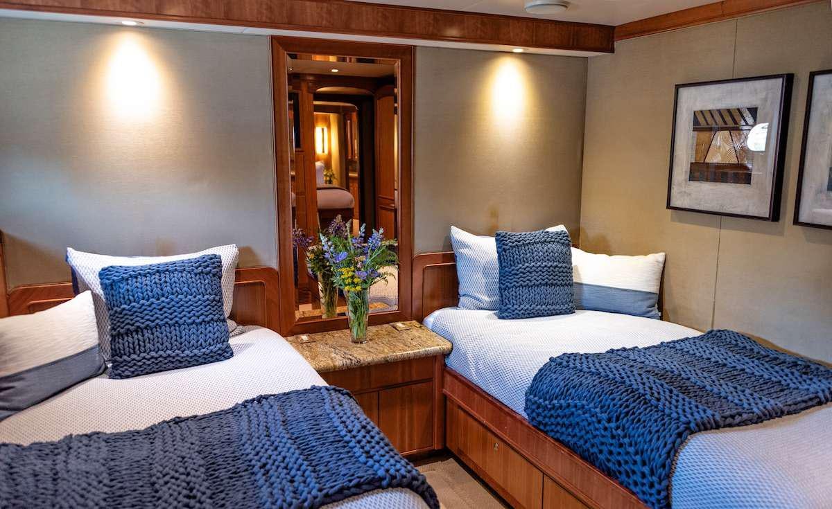 a couple of beds in a hotel room aboard DAUNTLESS Yacht for Charter