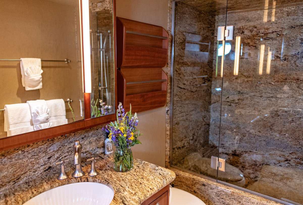 a bathroom with a large mirror aboard DAUNTLESS Yacht for Charter