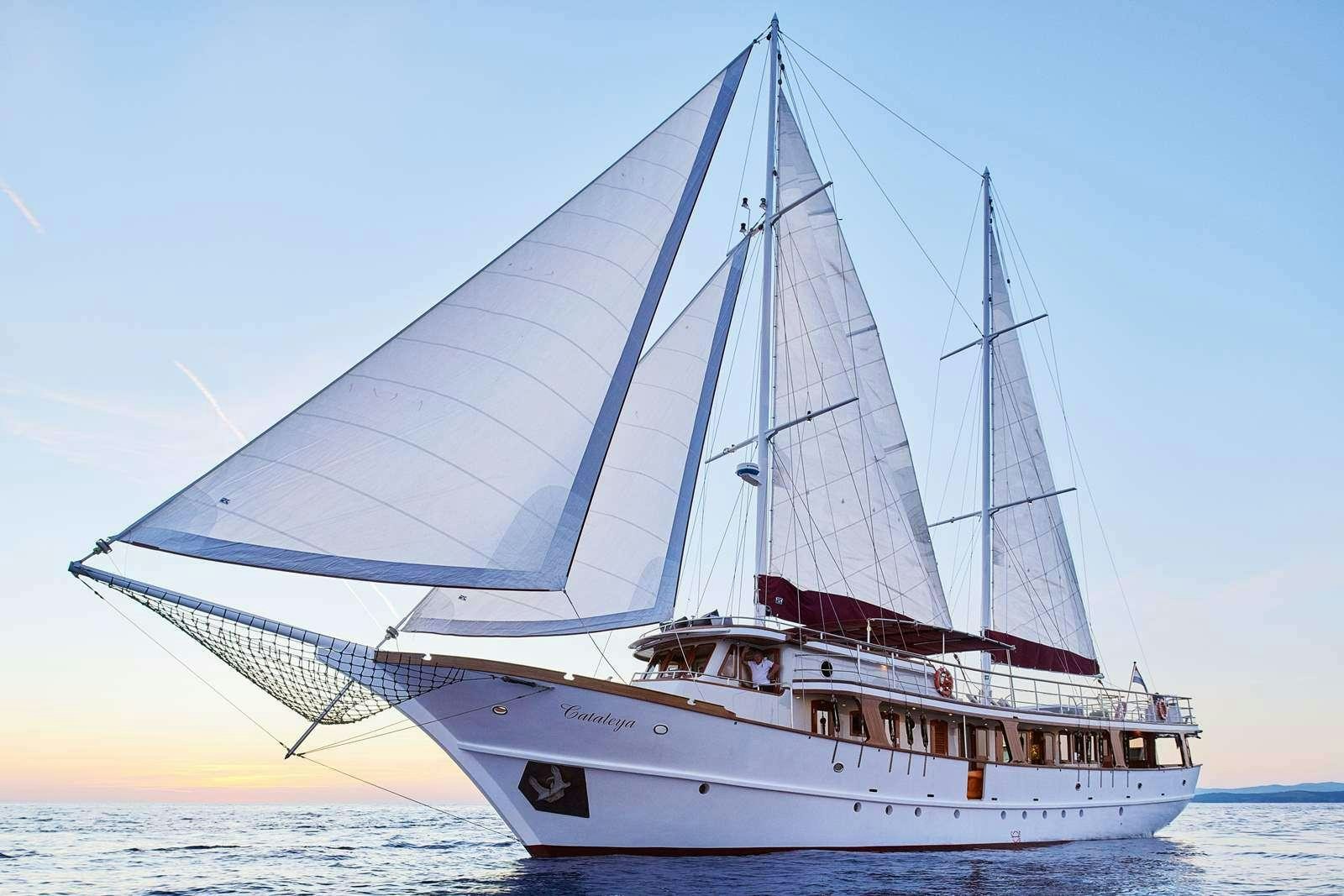 a large white boat in the water aboard CATALEYA Yacht for Charter