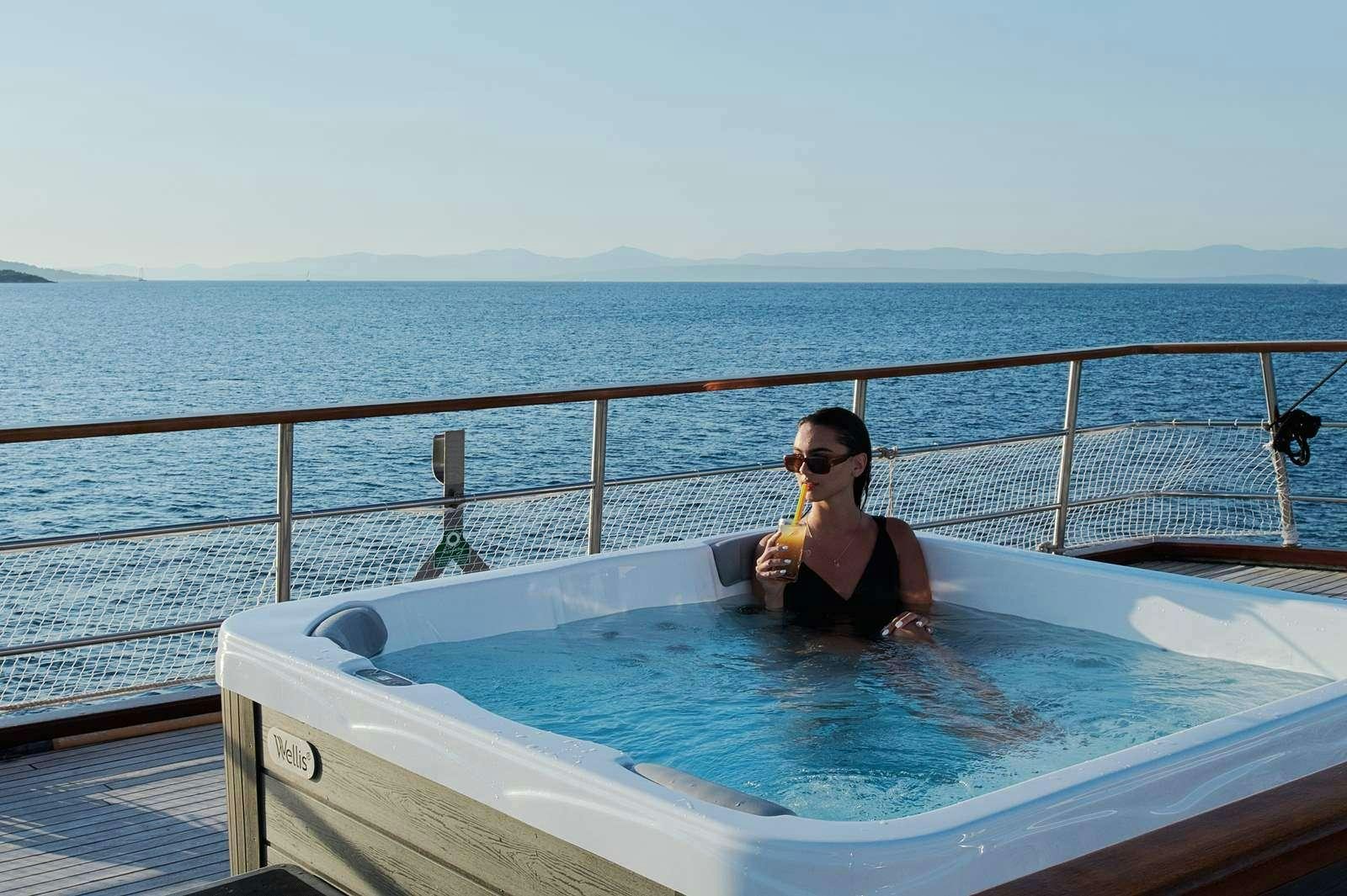 a person sitting in a pool aboard CATALEYA Yacht for Charter