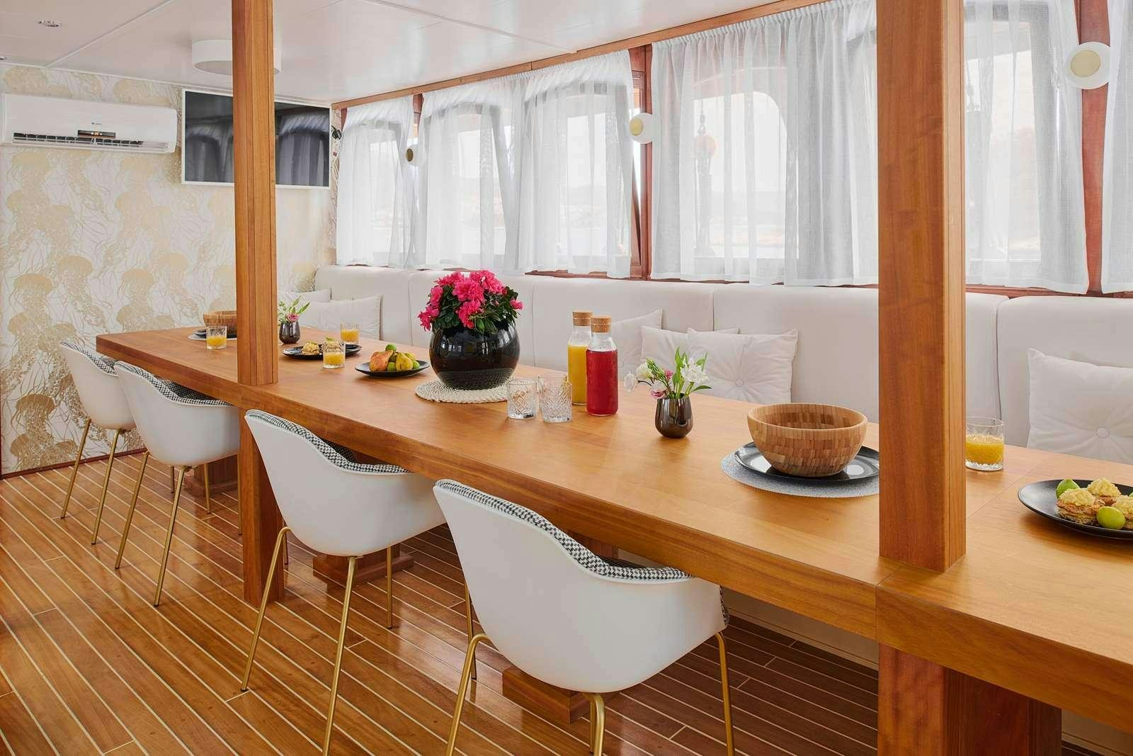 a kitchen with a table and chairs aboard CATALEYA Yacht for Charter