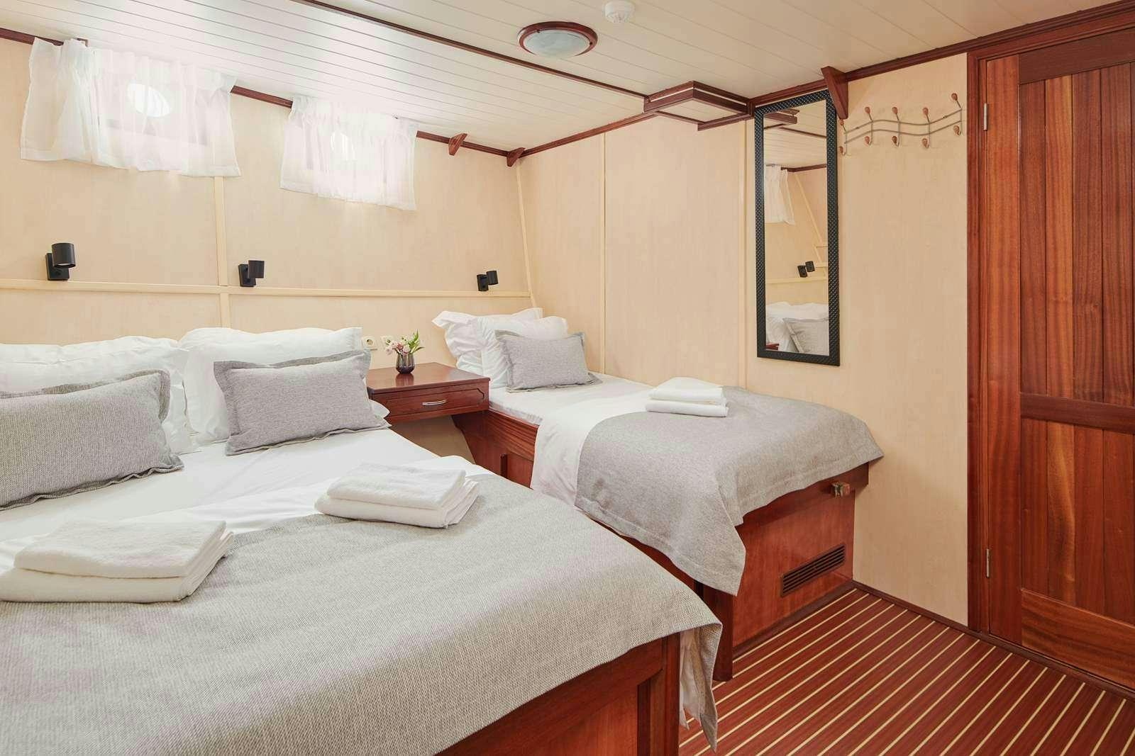 a room with two beds aboard CATALEYA Yacht for Charter