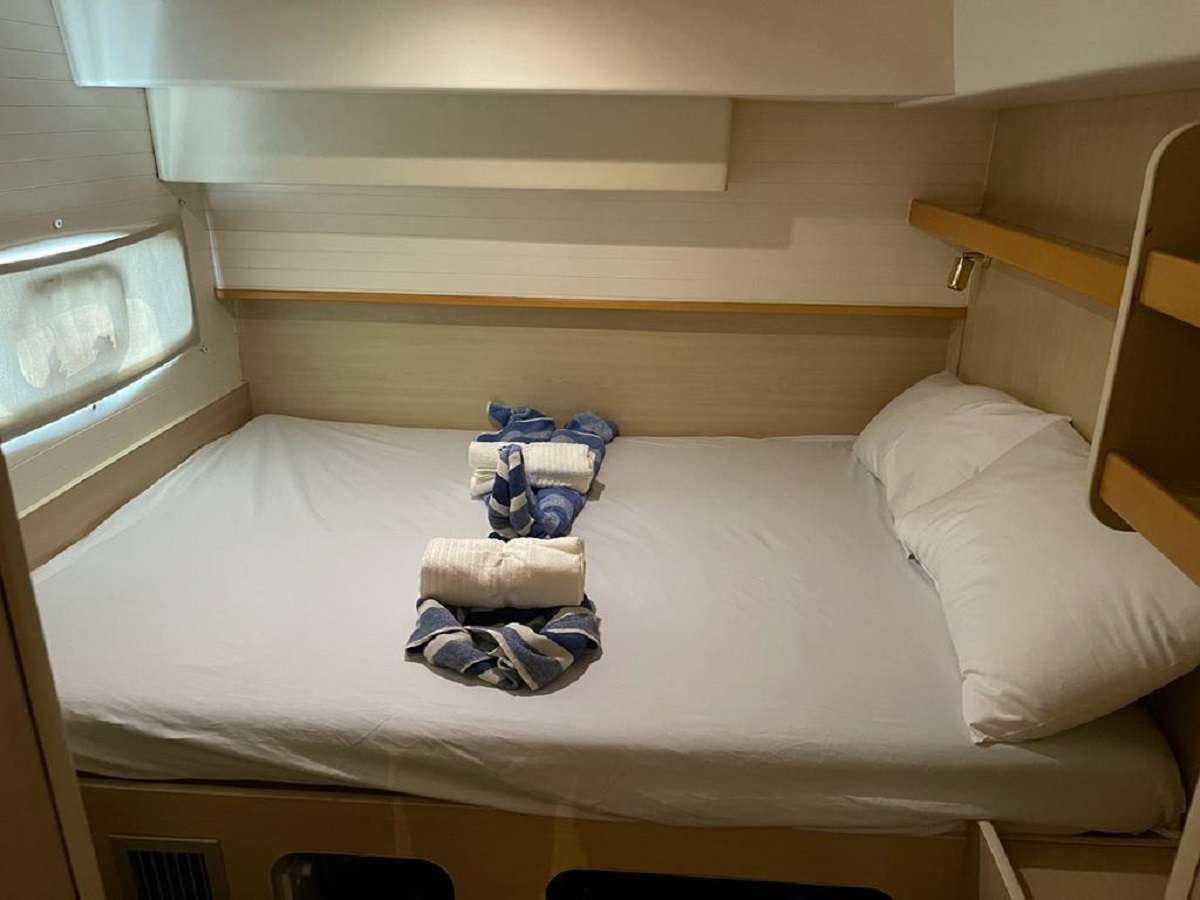 a bed with clothes on it aboard DREAM CORSICA Yacht for Charter