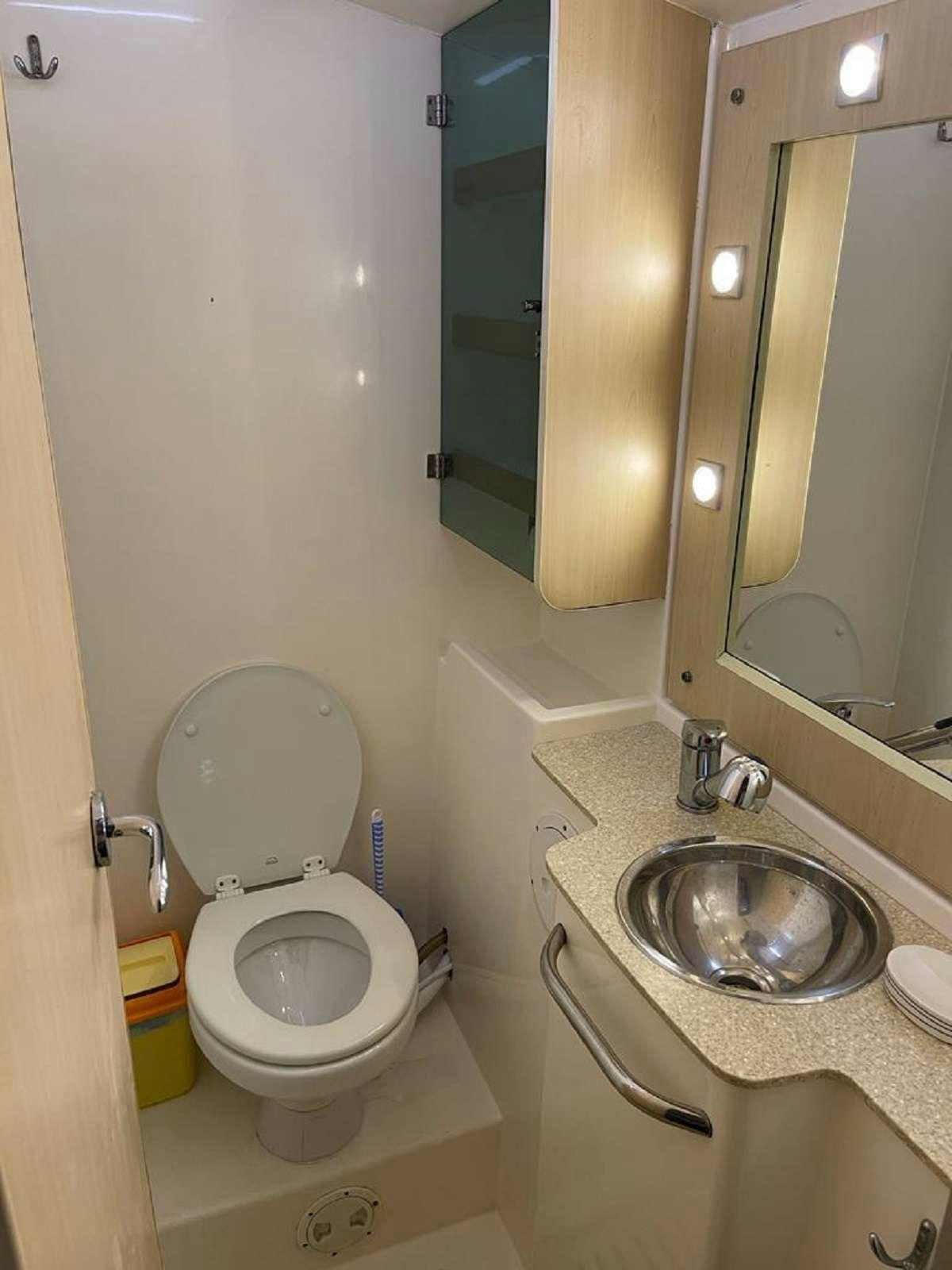 a bathroom with a toilet and sink aboard DREAM CORSICA Yacht for Charter