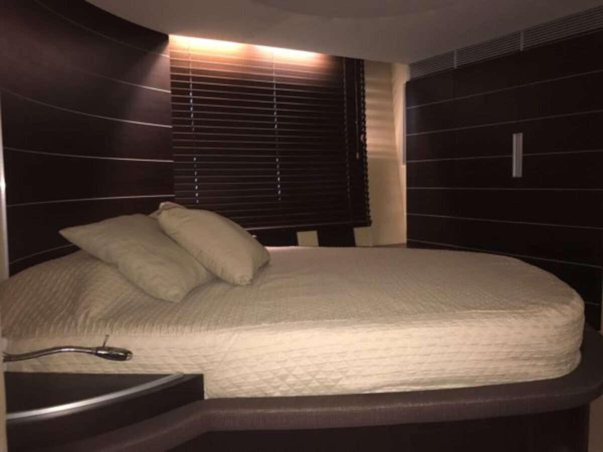 a bed with a white sheet aboard ZIPI ZAPE Yacht for Charter