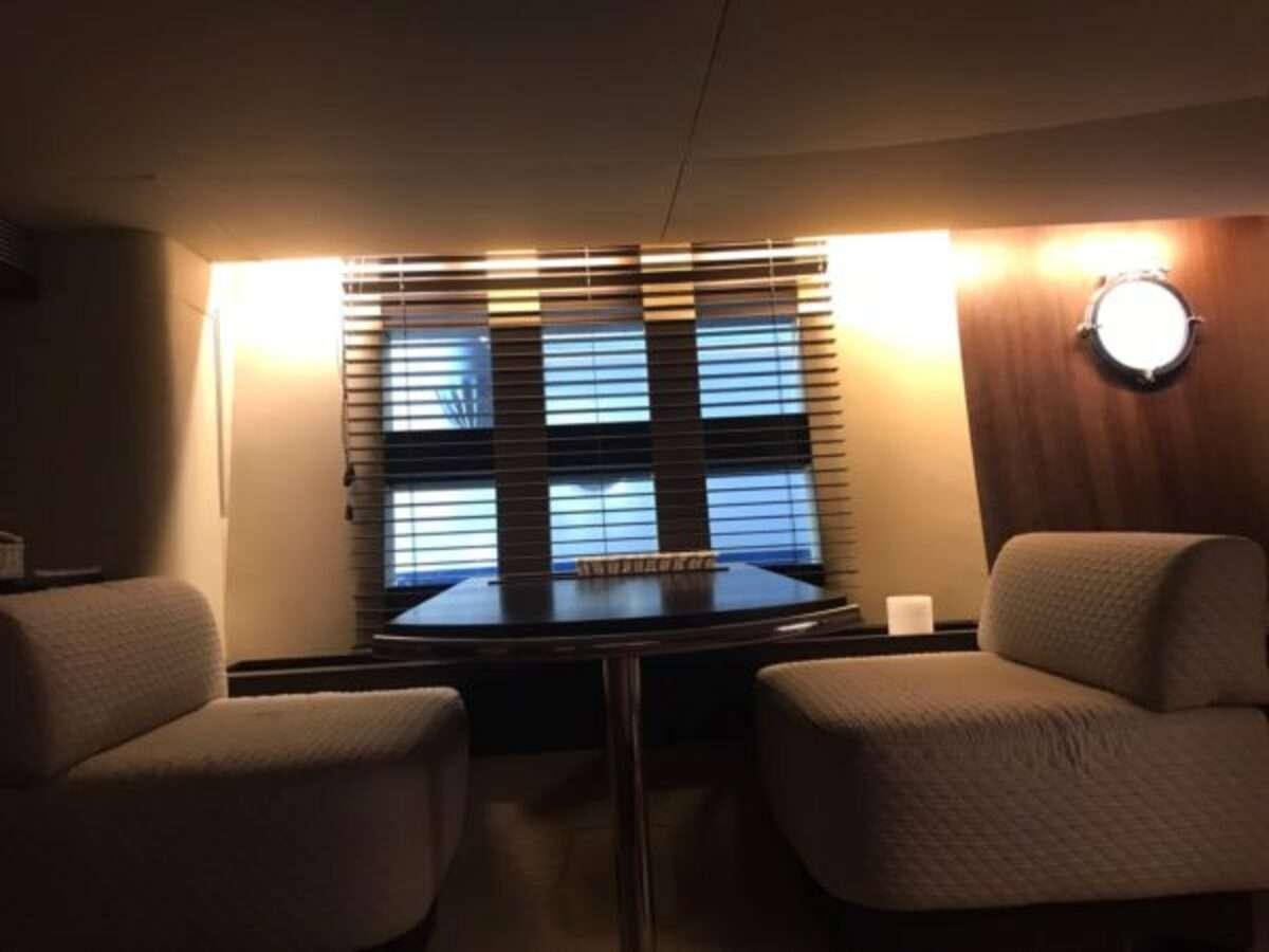 a room with a table and chairs aboard ZIPI ZAPE Yacht for Charter