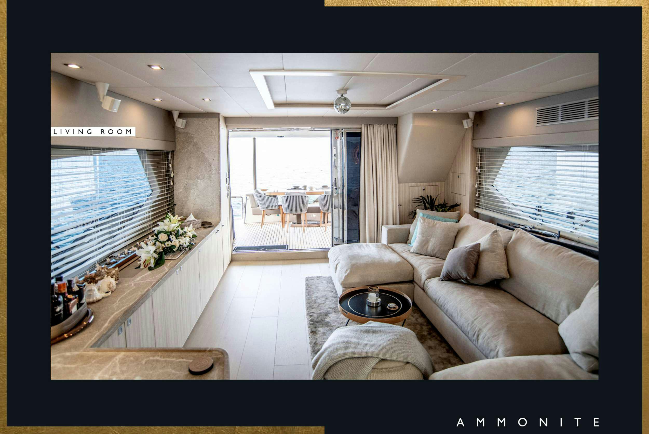 a living room with a couch and a table aboard AMMONITE Yacht for Charter