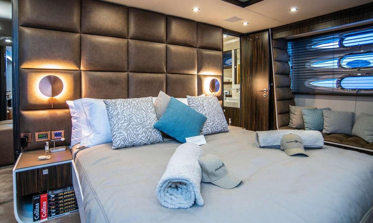 a bed with pillows and pillows aboard AMMONITE Yacht for Charter
