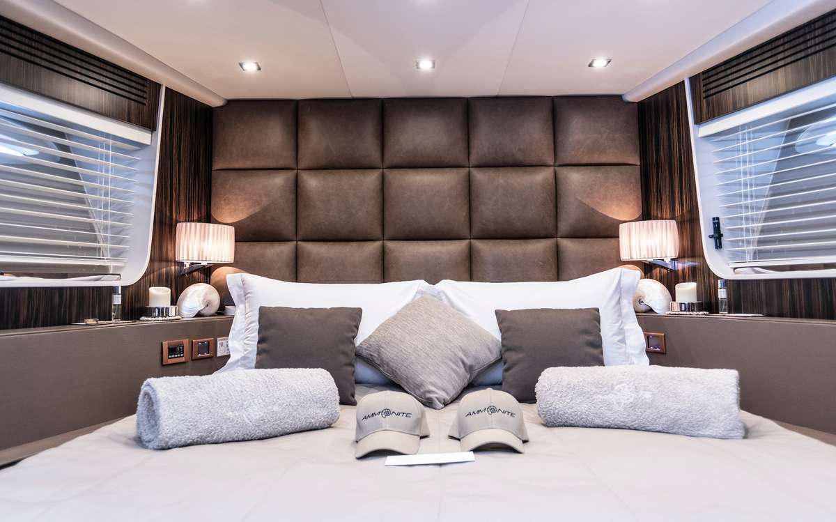 a large bed with pillows aboard AMMONITE Yacht for Charter