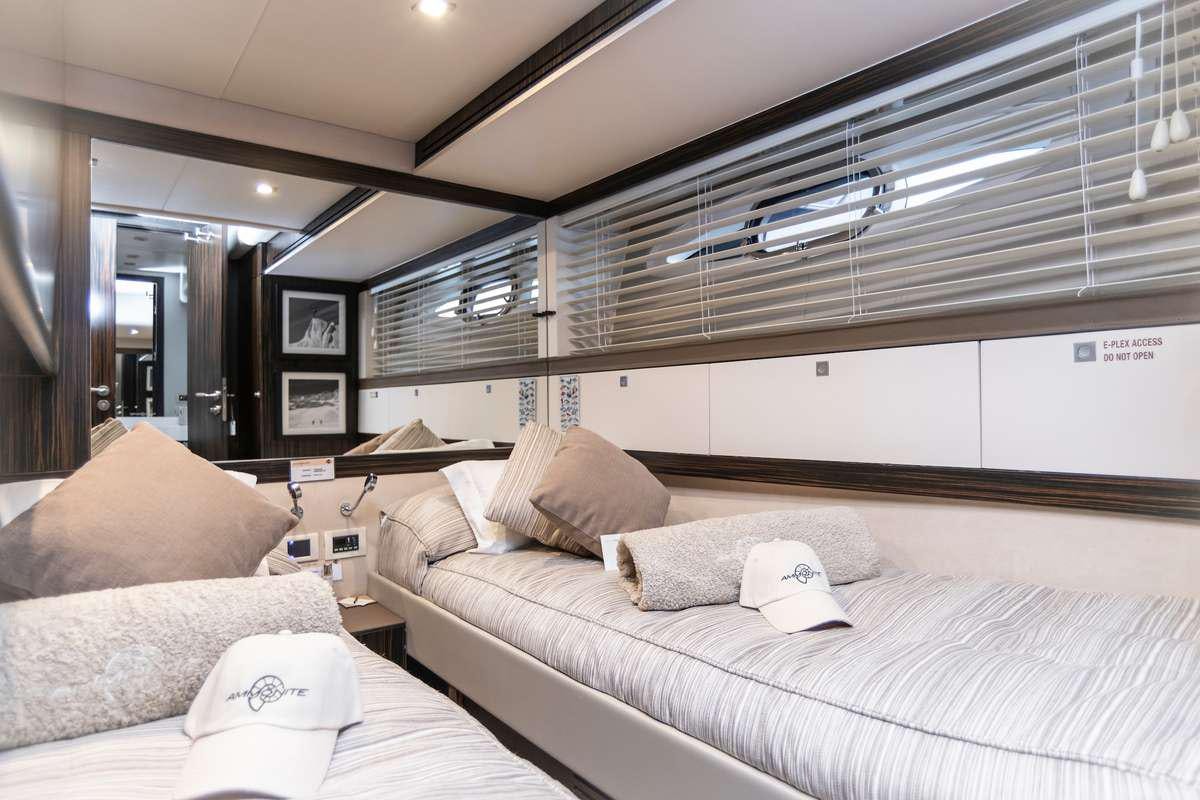 a room with a bed and a window aboard AMMONITE Yacht for Charter