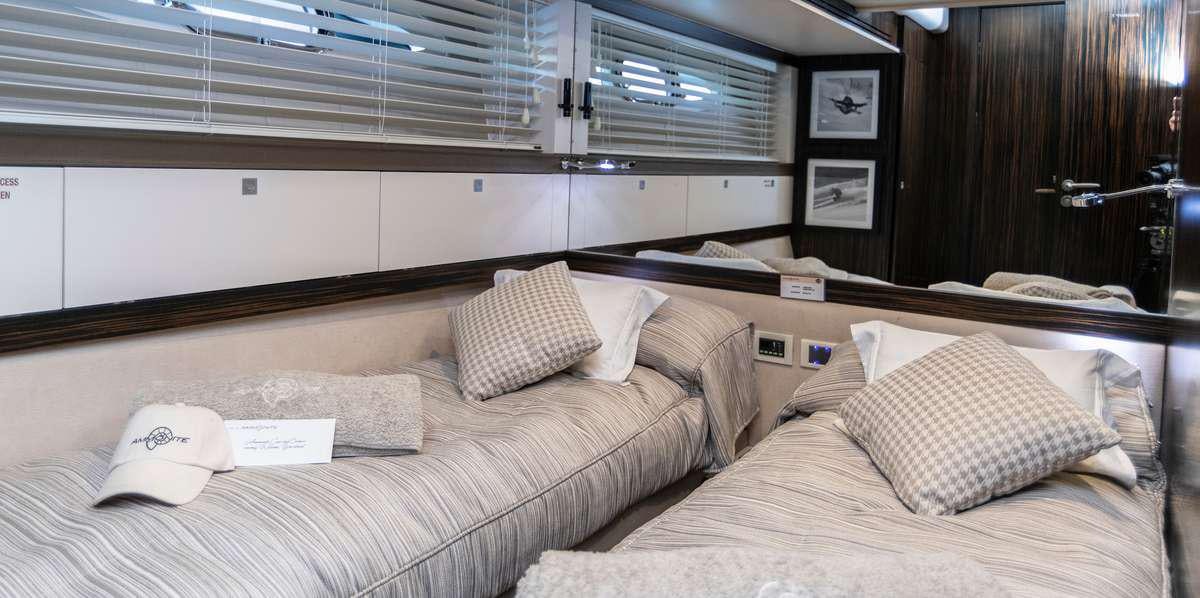 a bed with pillows aboard AMMONITE Yacht for Charter