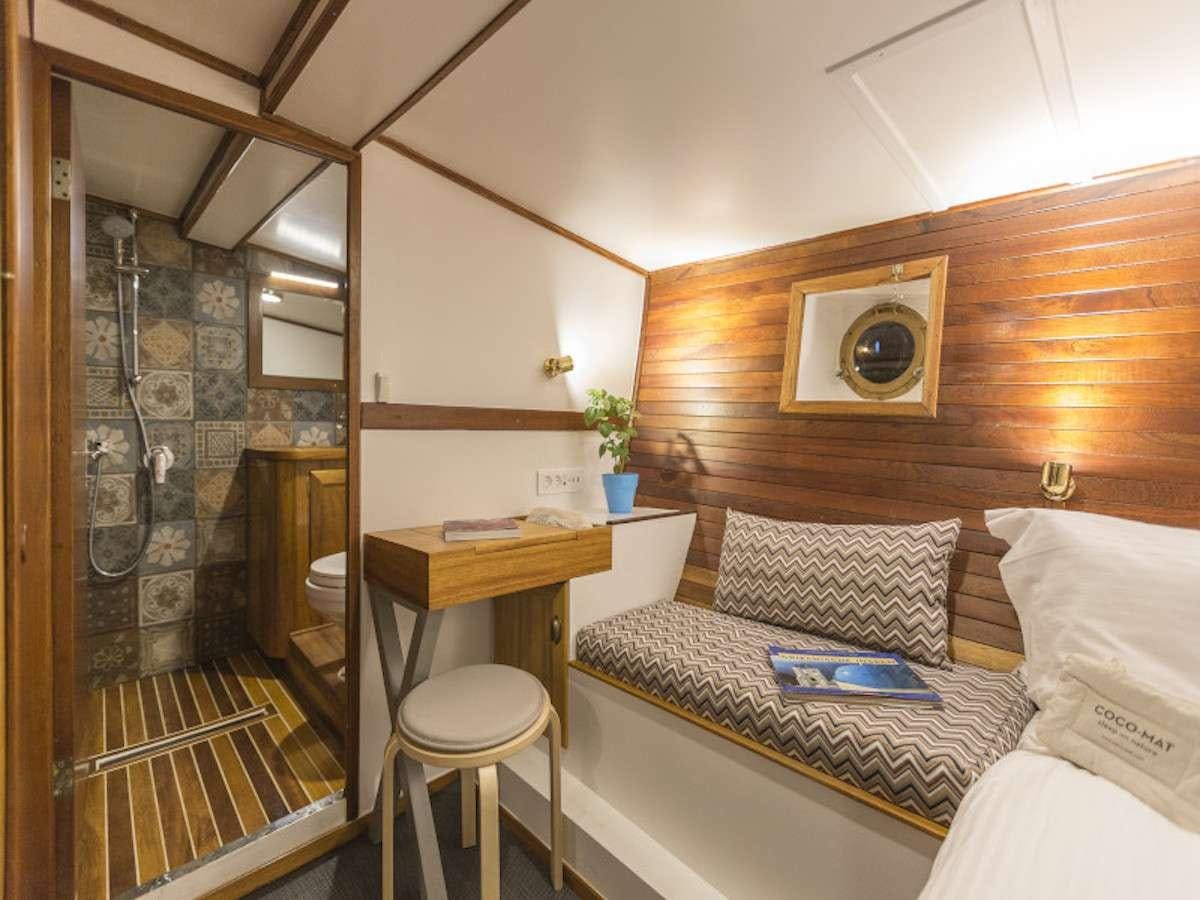 a bed in a room aboard COSMOS Yacht for Charter