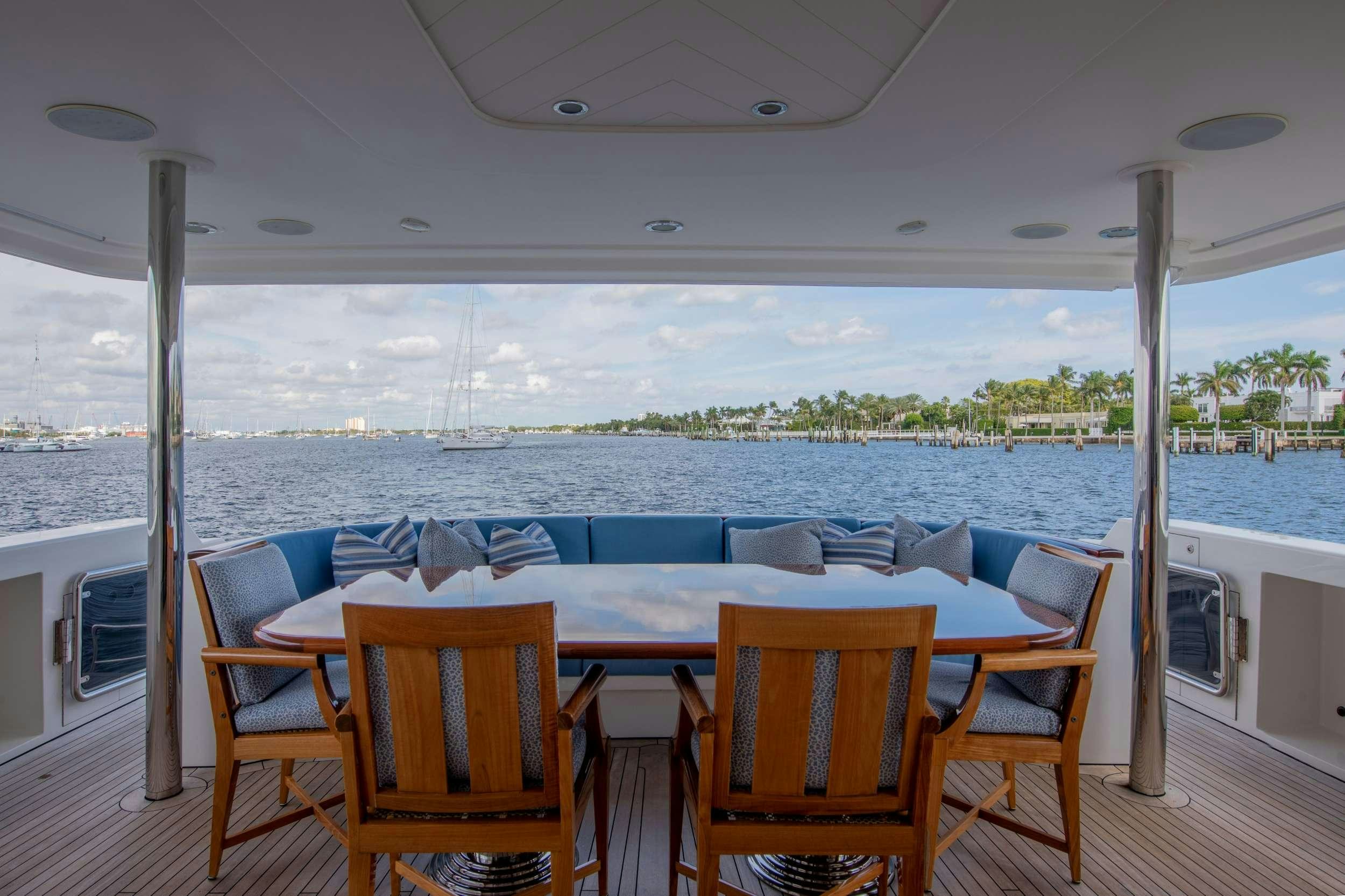 a table and chairs on a deck aboard SPIRIT Yacht for Charter