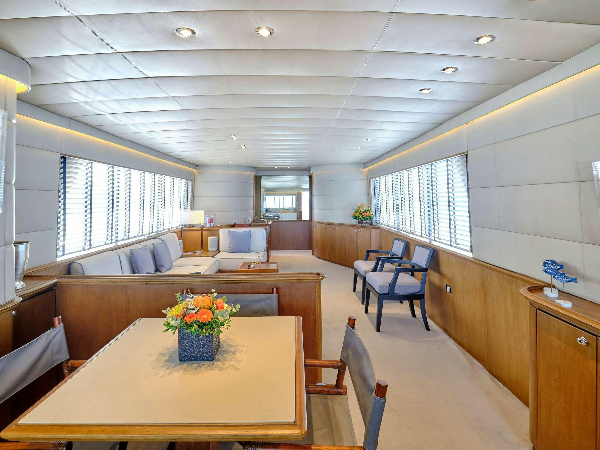a large room with a table and chairs aboard ALAYA Yacht for Charter