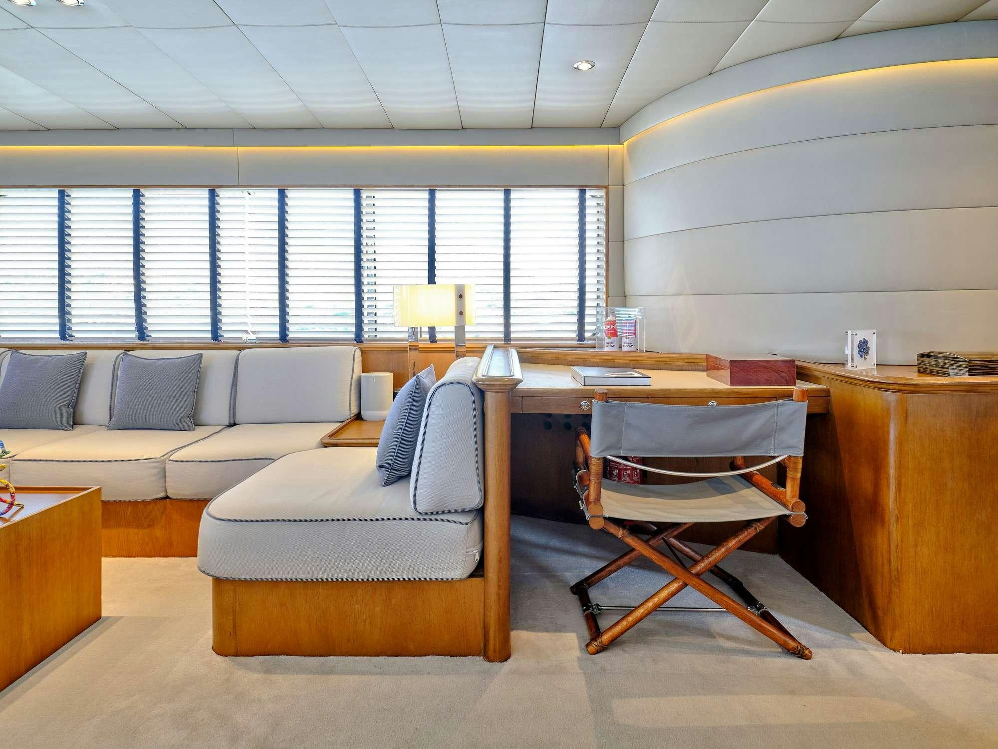 a room with a couch and a chair aboard ALAYA Yacht for Charter