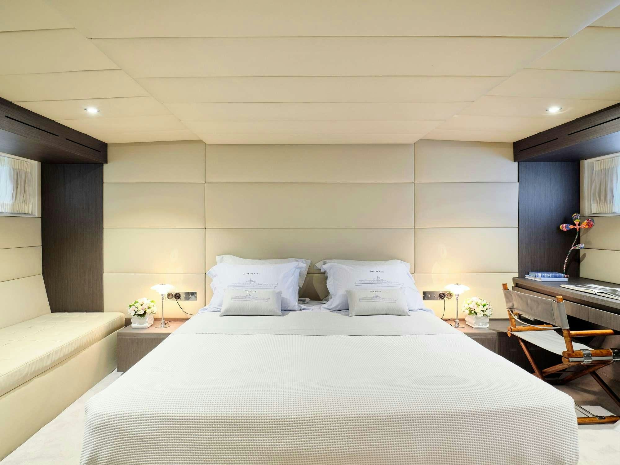 a bed with white sheets aboard ALAYA Yacht for Charter