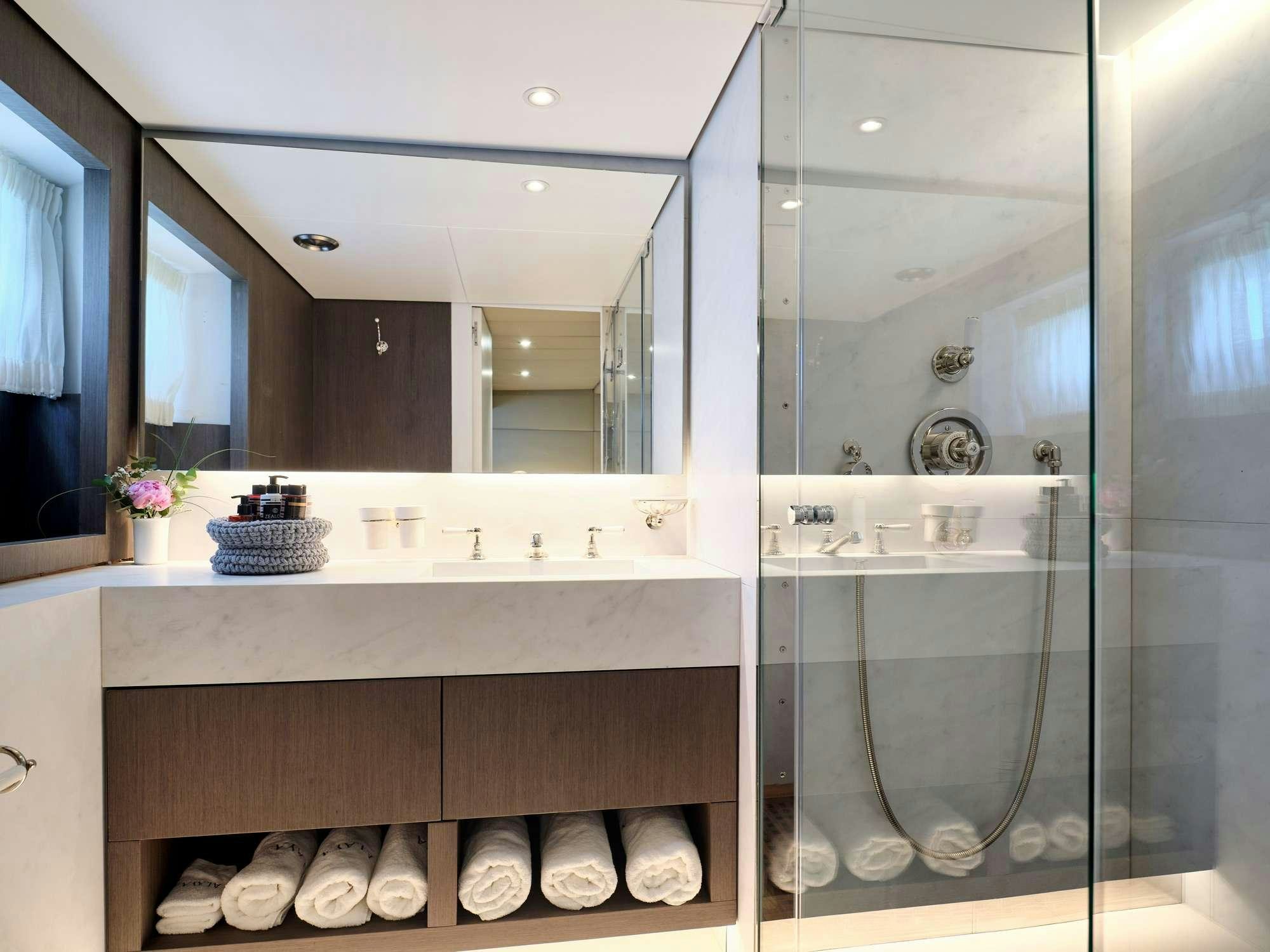 a bathroom with a glass shower aboard ALAYA Yacht for Charter