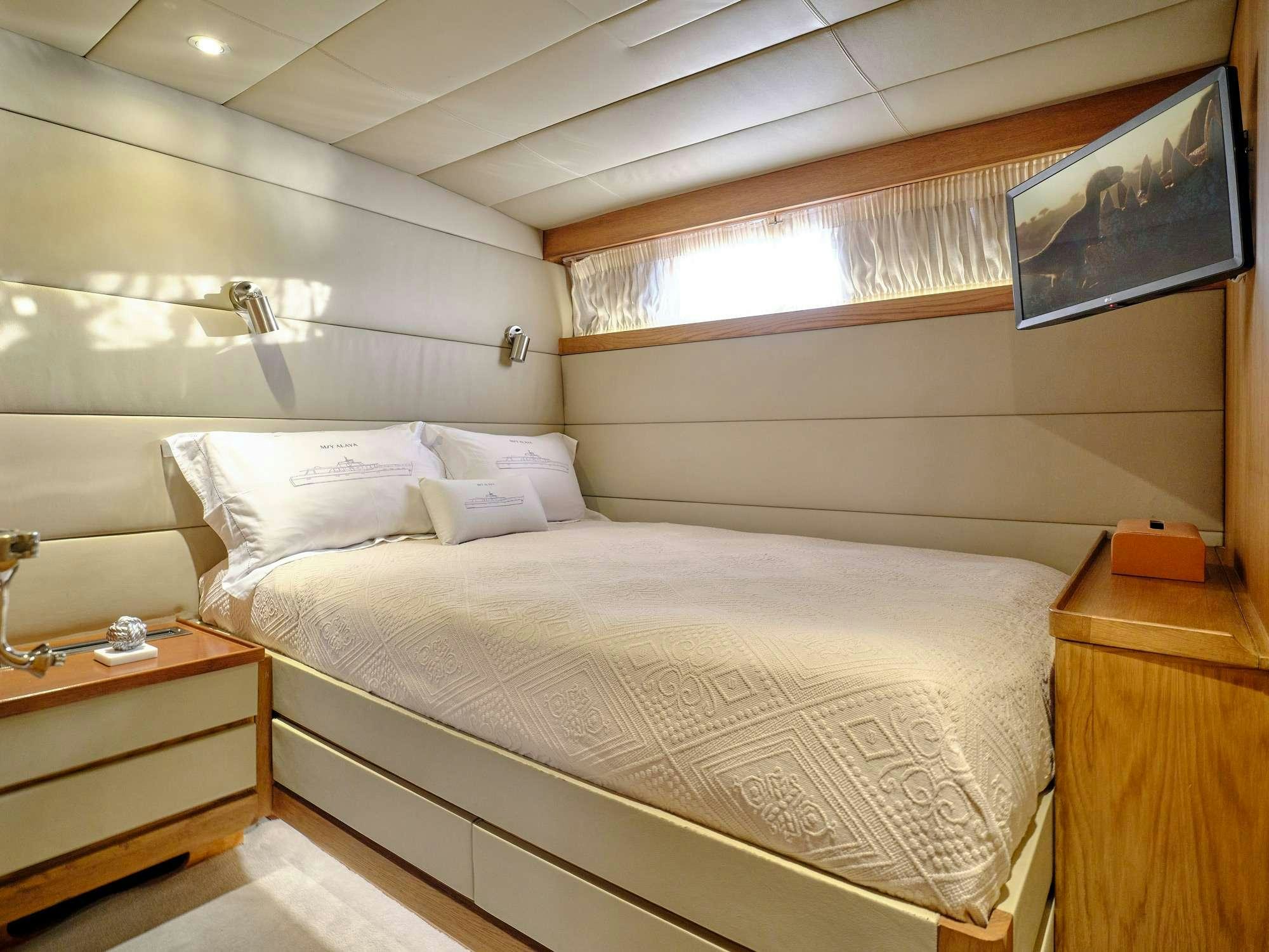 a bed with white sheets aboard ALAYA Yacht for Charter