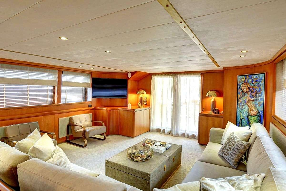 a living room with a couch and a coffee table aboard KARMA Yacht for Charter