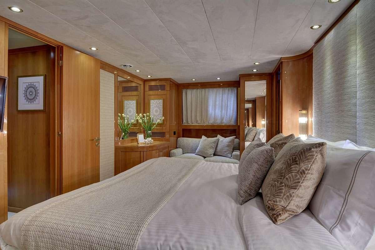 a bed with pillows and a mirror aboard KARMA Yacht for Charter