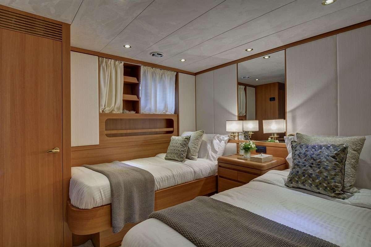 a couple of beds in a hotel room aboard KARMA Yacht for Charter