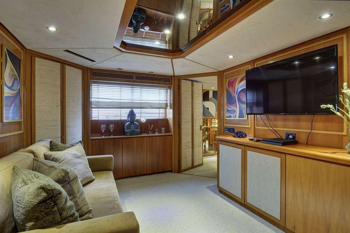 a living room with a couch and tv aboard KARMA Yacht for Charter